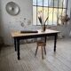 Oak farmhouse table with turned black legs.