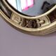 Antique medallion mirror with a gilded and relief-carved frame.