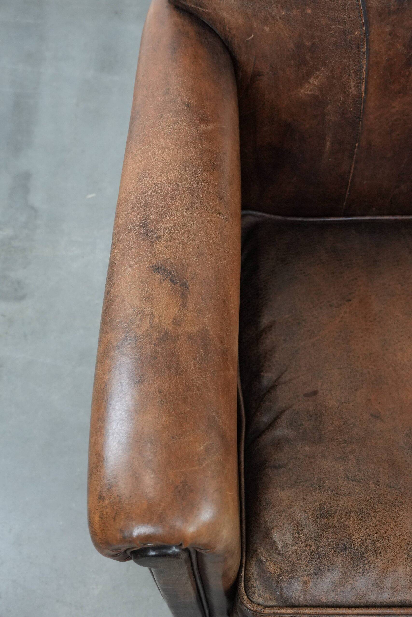 Set of 2 vintage sheepskin armchairs with a characterful appearance