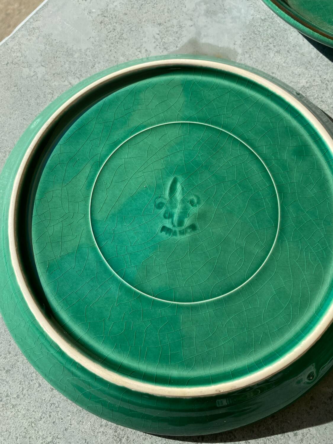 Many glazed stoneware plates with compartments.