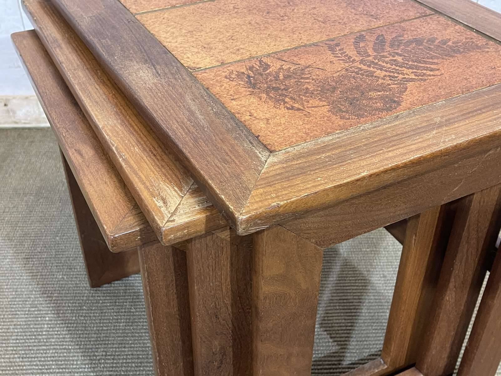 Set of 3 nesting tables in teak with tiled tops.