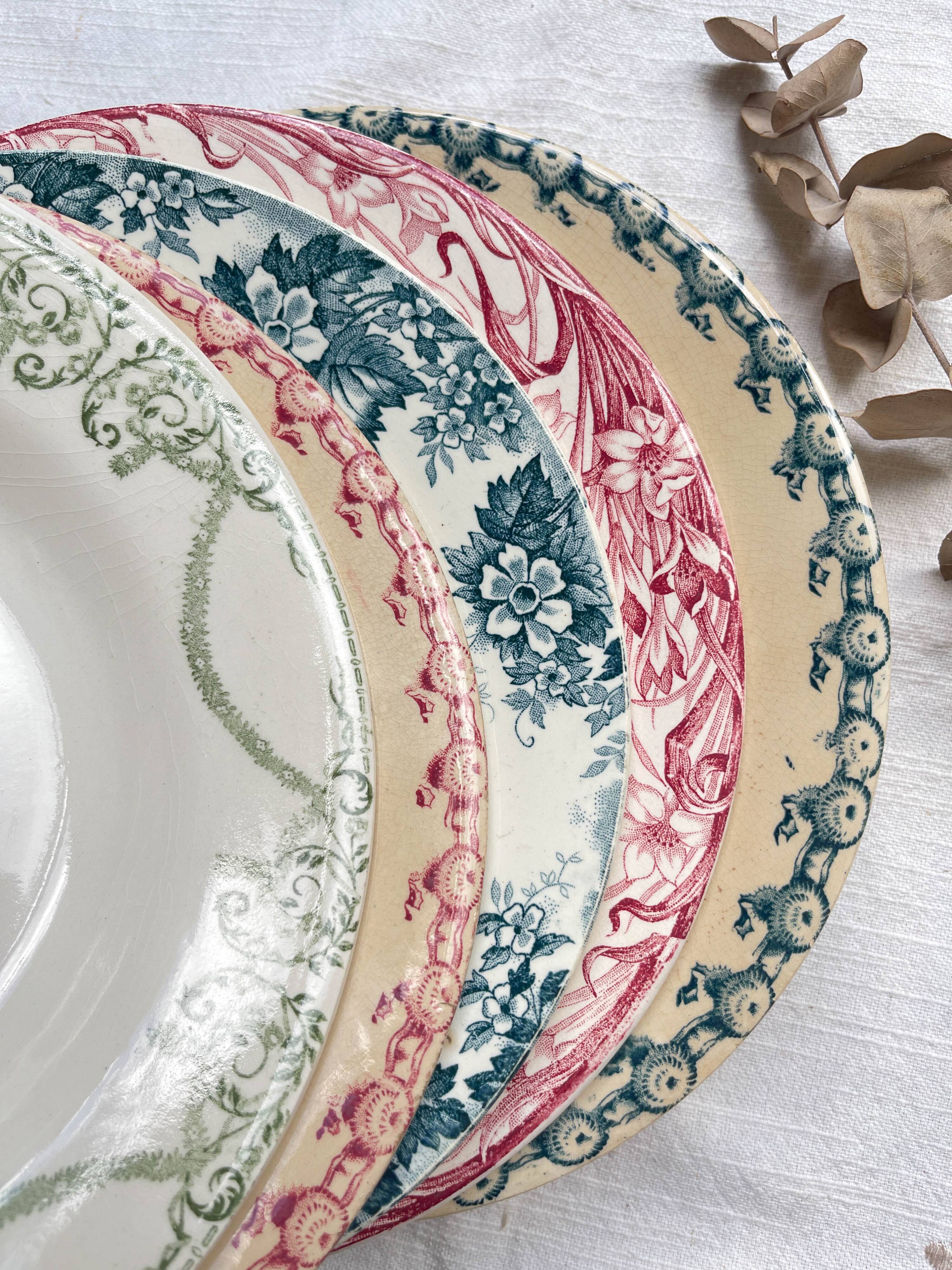 10 mismatched vintage soup plates in blue, green, and red ironstone