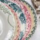 10 mismatched vintage soup plates in blue, green, and red ironstone