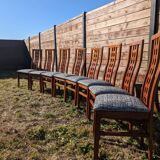 Set of 8 teak lounge chairs with high backs and zebra-striped seats