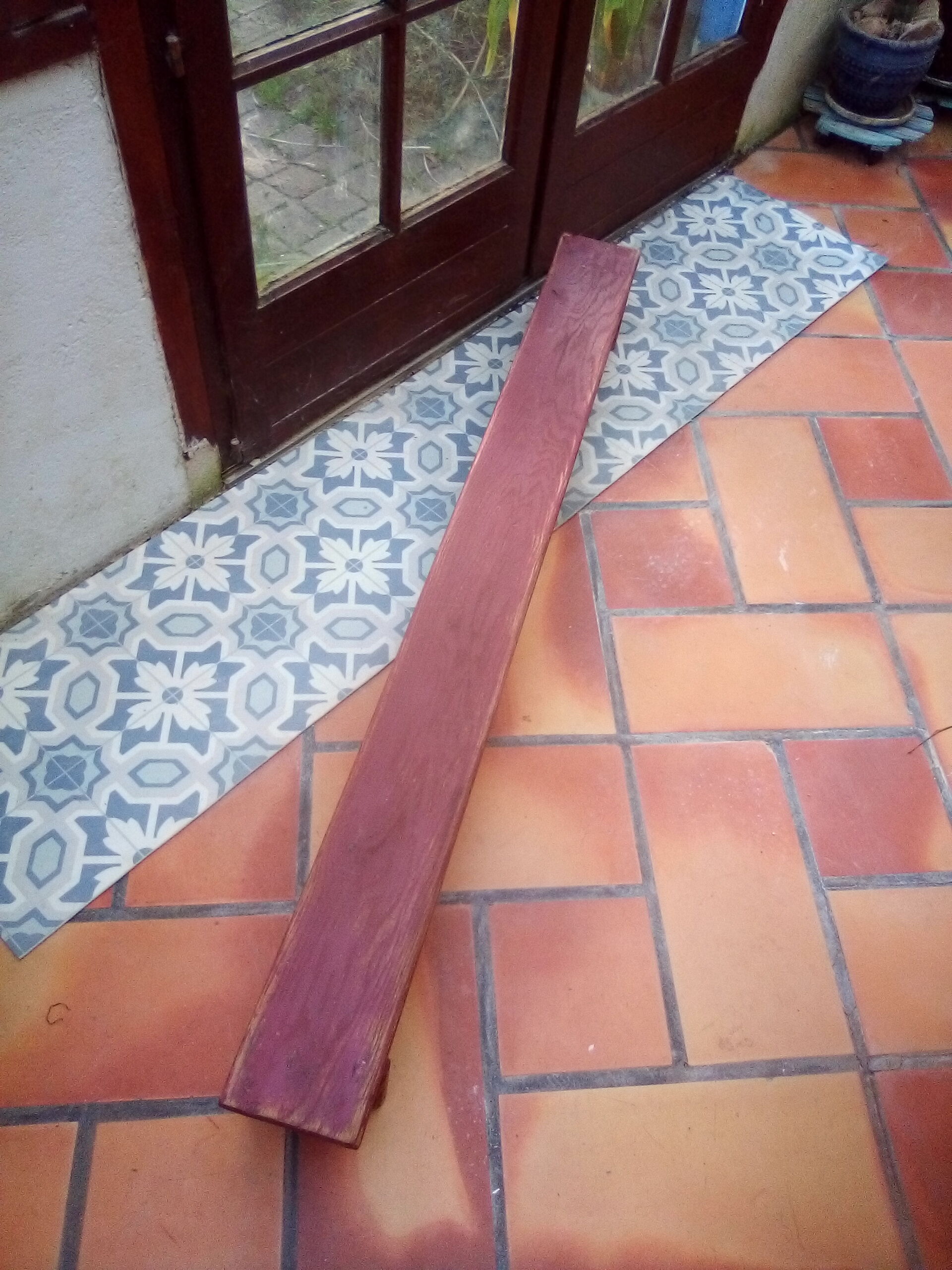 Low bench rests feet in patinated wood