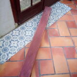Low bench rests feet in patinated wood