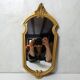 Antique Louis XV style mirror with a vintage carved gold frame.