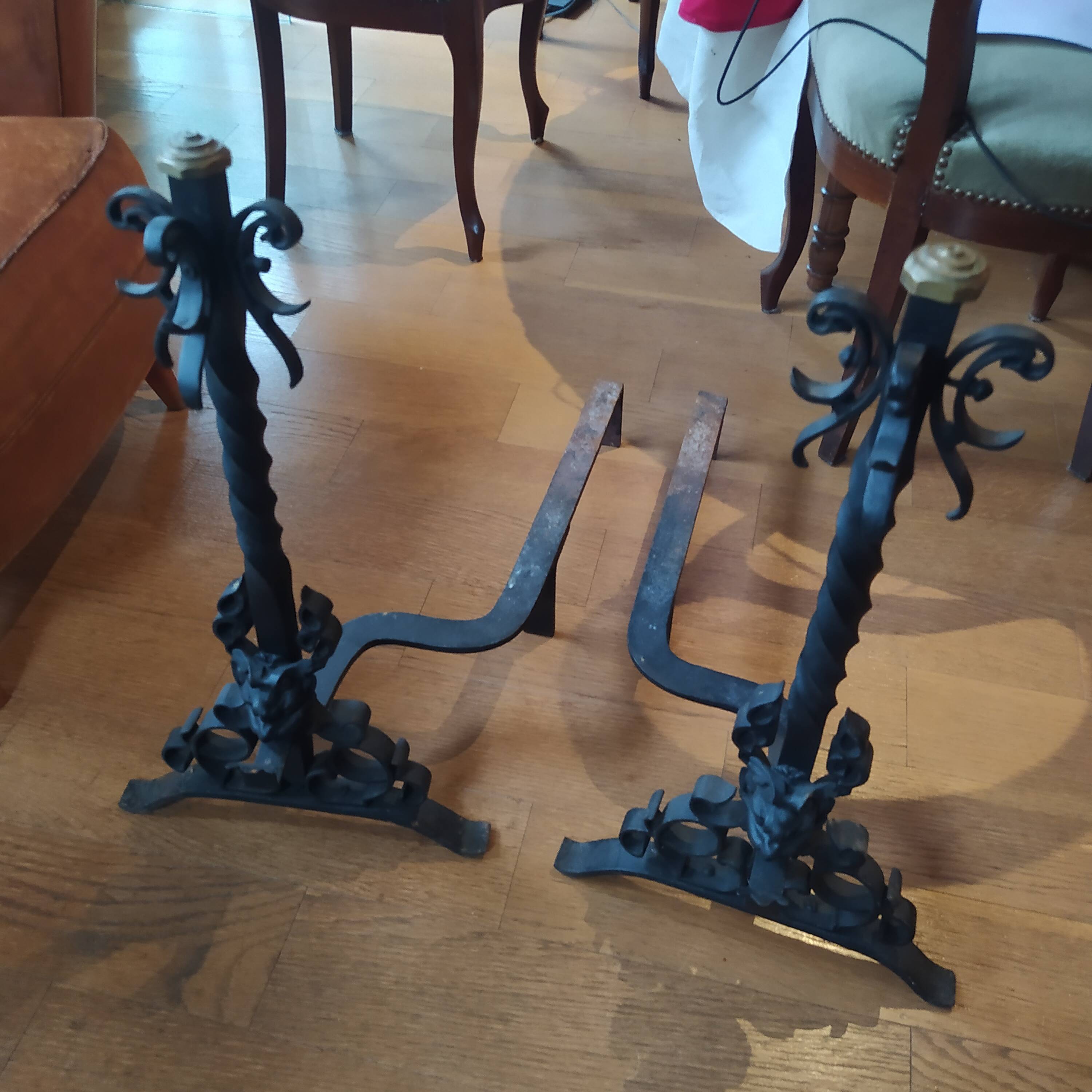 pair of large 20th century metal andirons with mascaron decoration