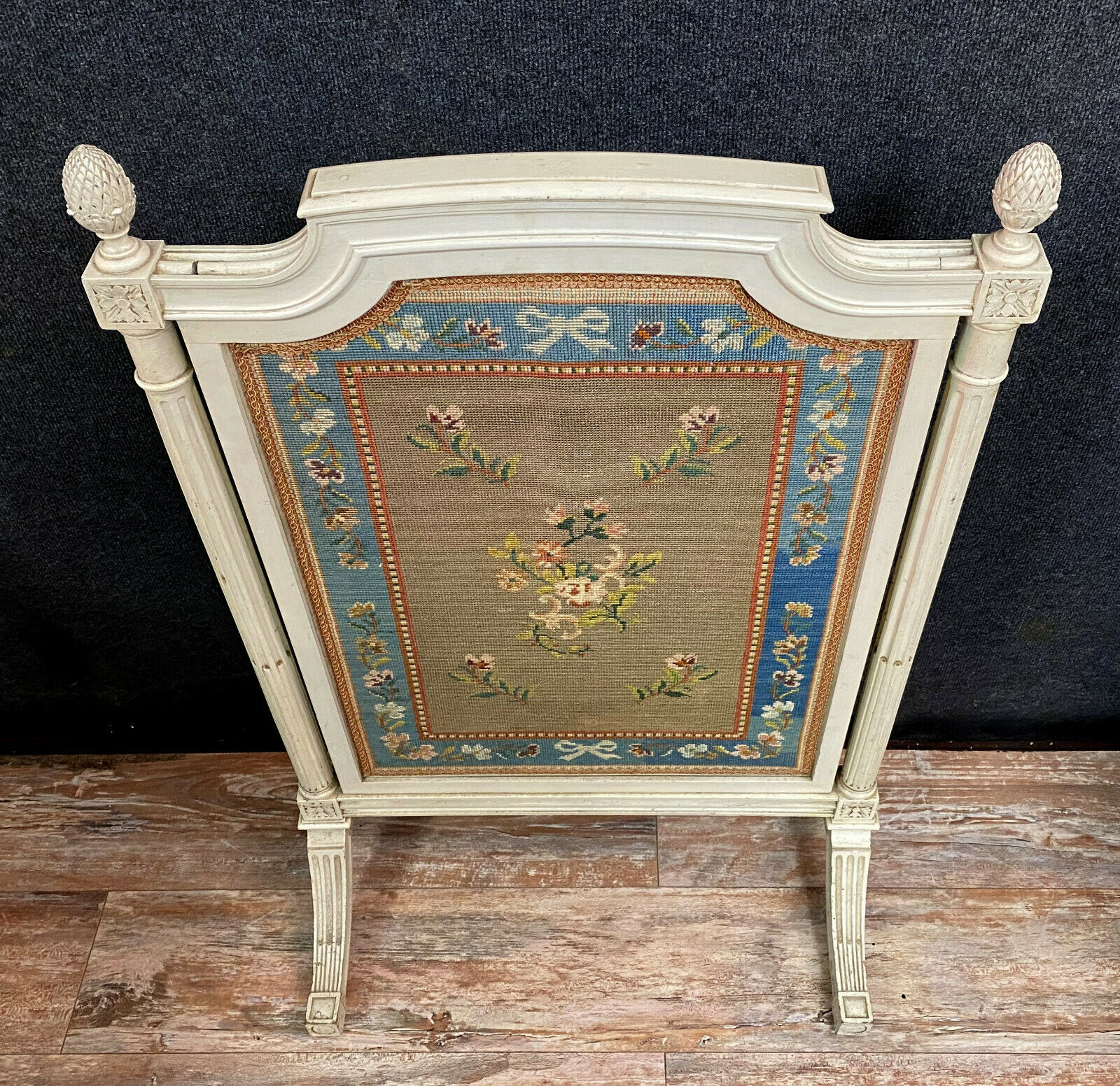 Front of Louis XVI fireplace in laqué wood and fabric has floral decorations