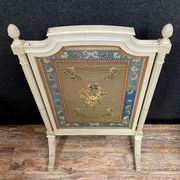 Front of Louis XVI fireplace in laqué wood and fabric has floral decorations