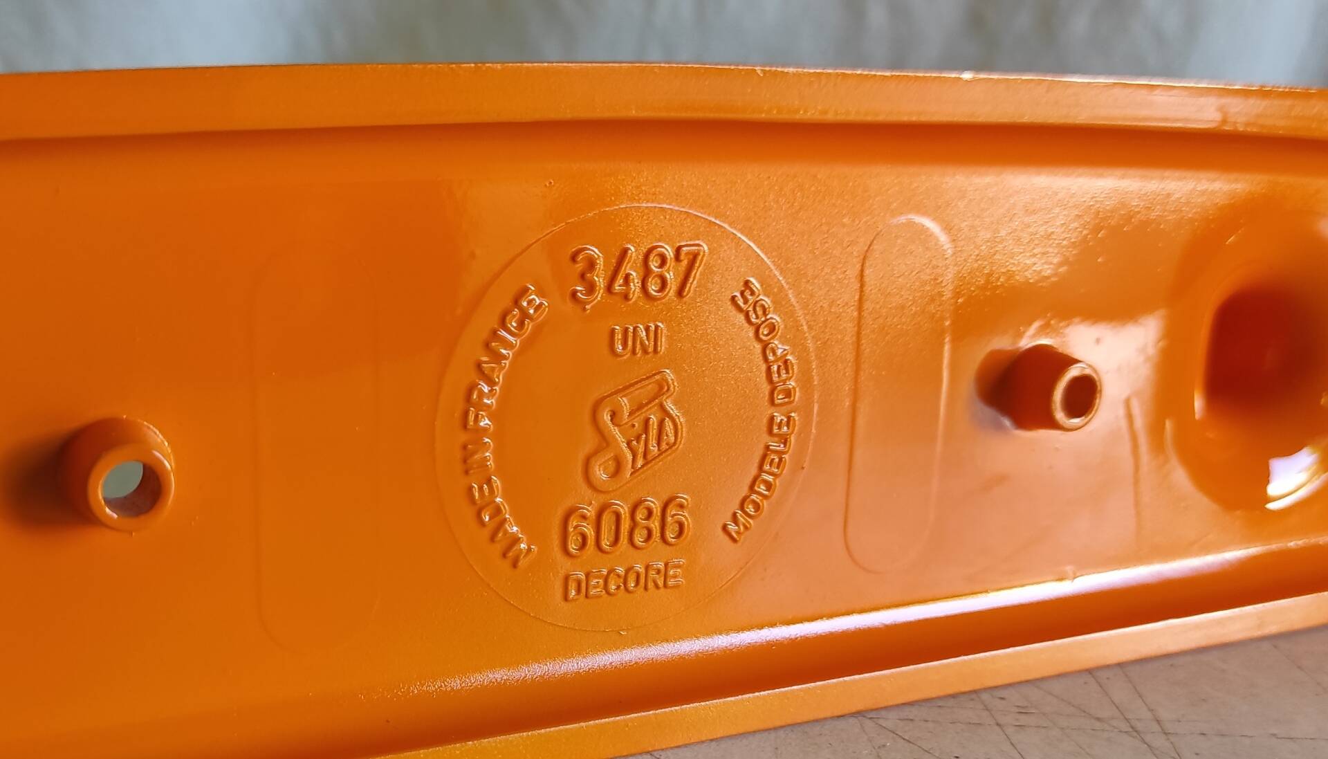 Orange plastic coat rack by Syla - 70's