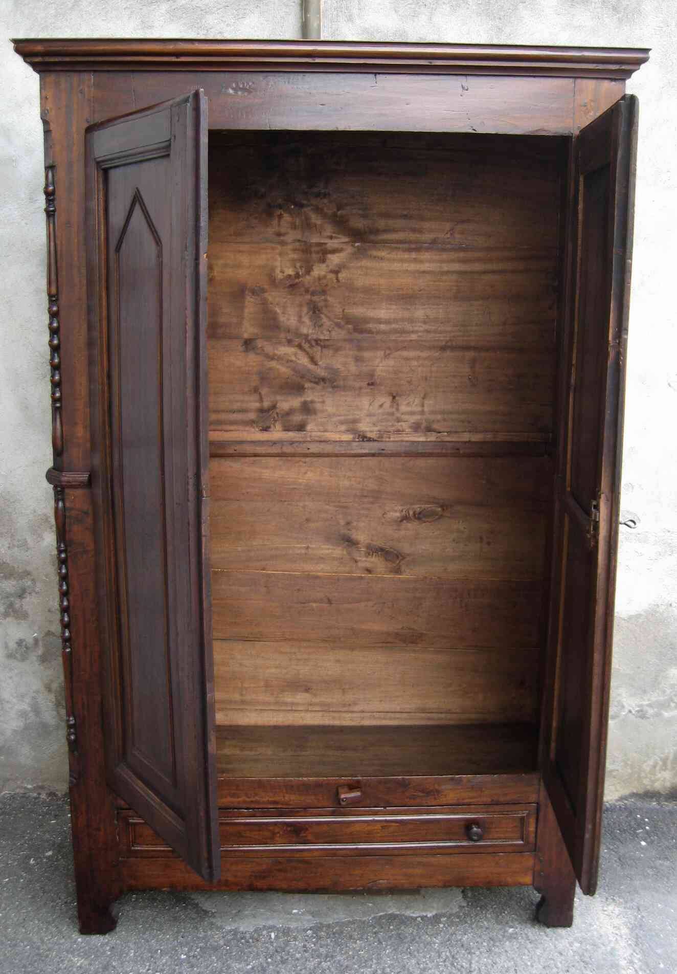 Antique solid wood wardrobe in historical rustic style from the 19th century.