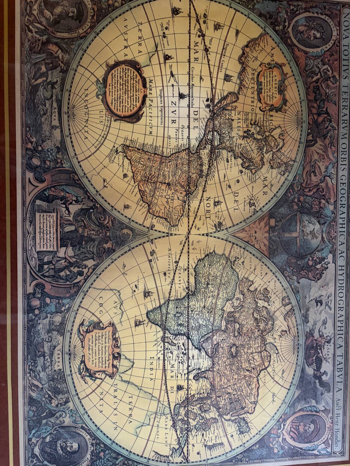 Wood and brass coffee table with a world map under glass.
