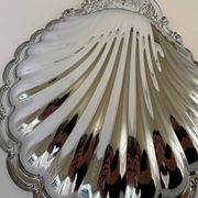 Large silver-plated serving dish in the shape of a vintage shell.