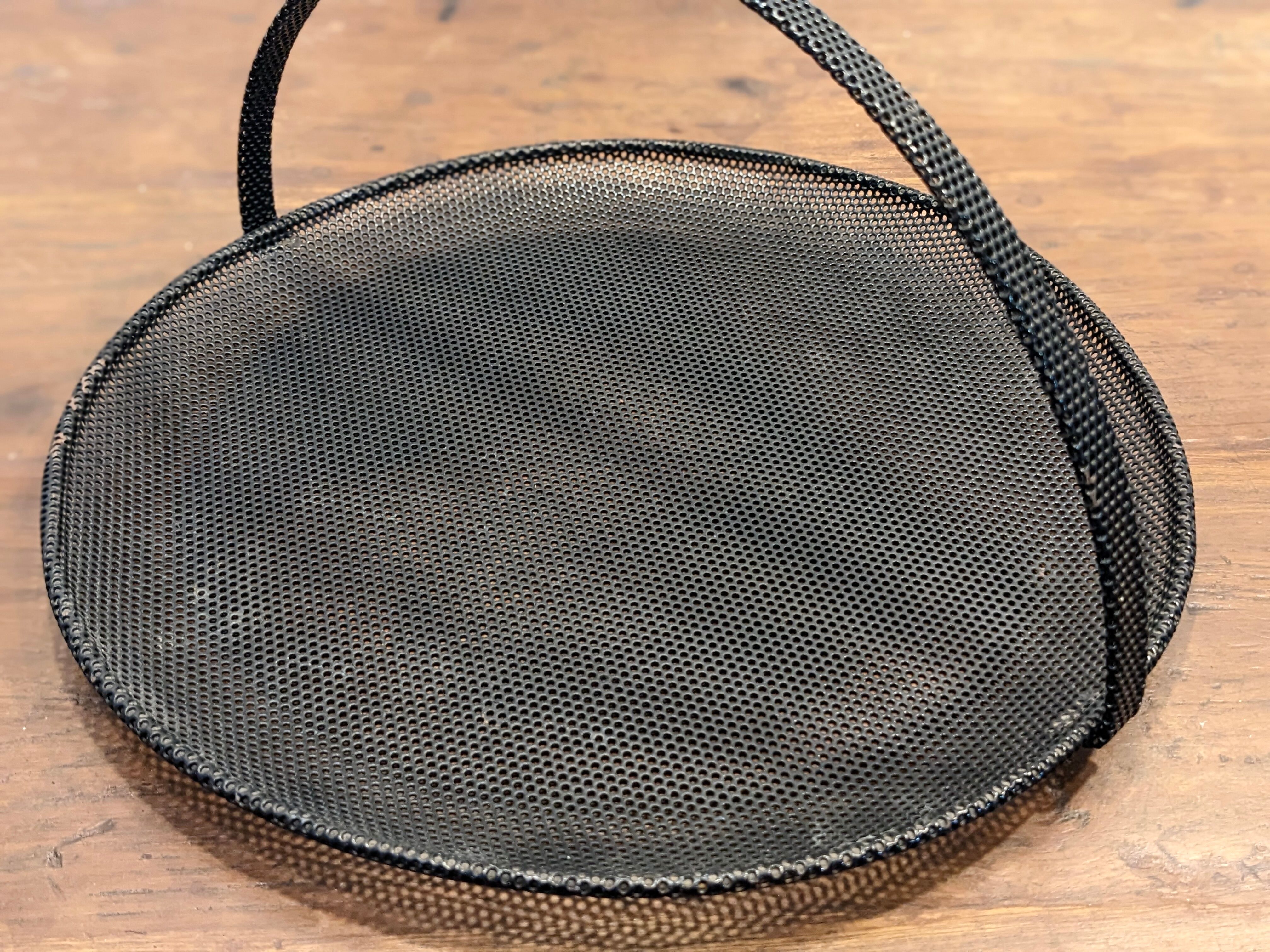 Black metal basket by Mathieu Mategot