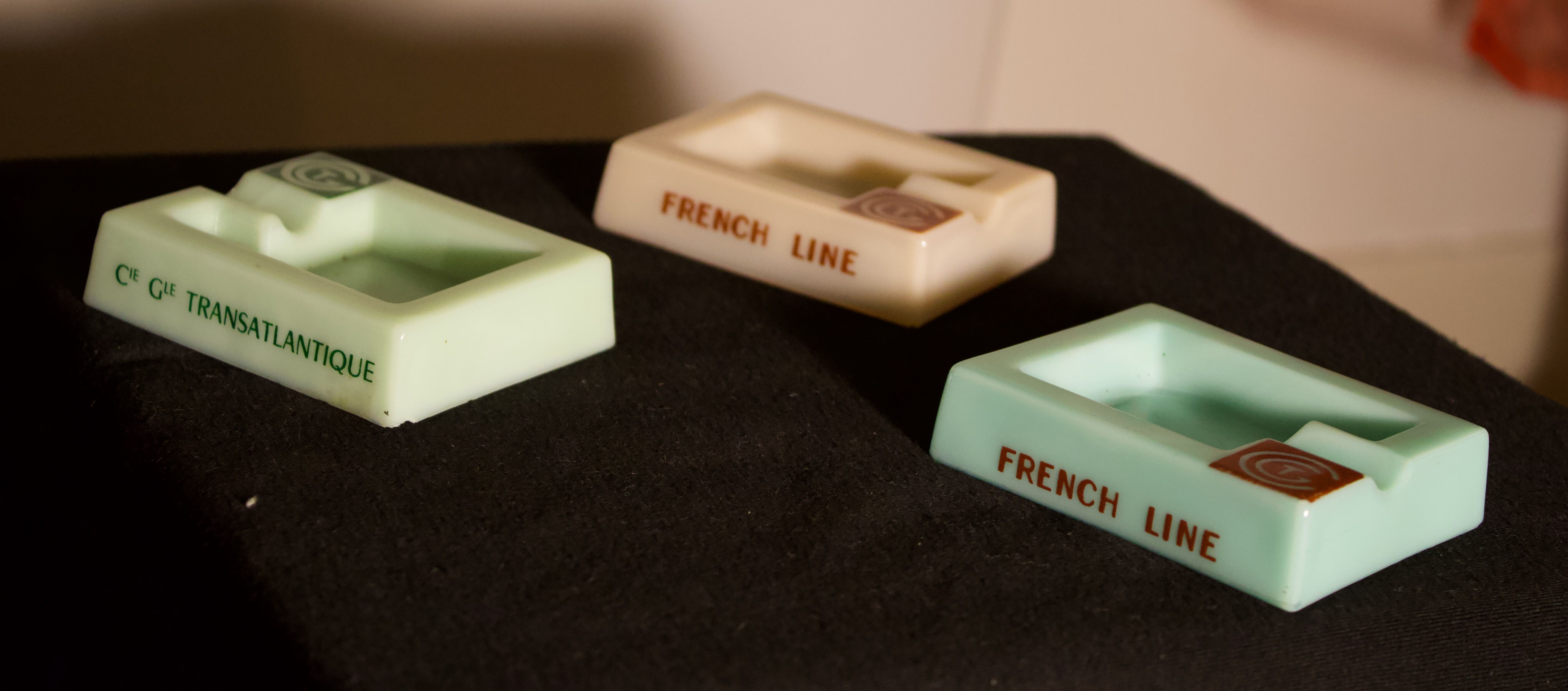 Three opalex ashtrays at the Logo of the Trans-Atlantic General Company - French Line - Model created by Jean Luce for the cruises of the liner Normandy and France