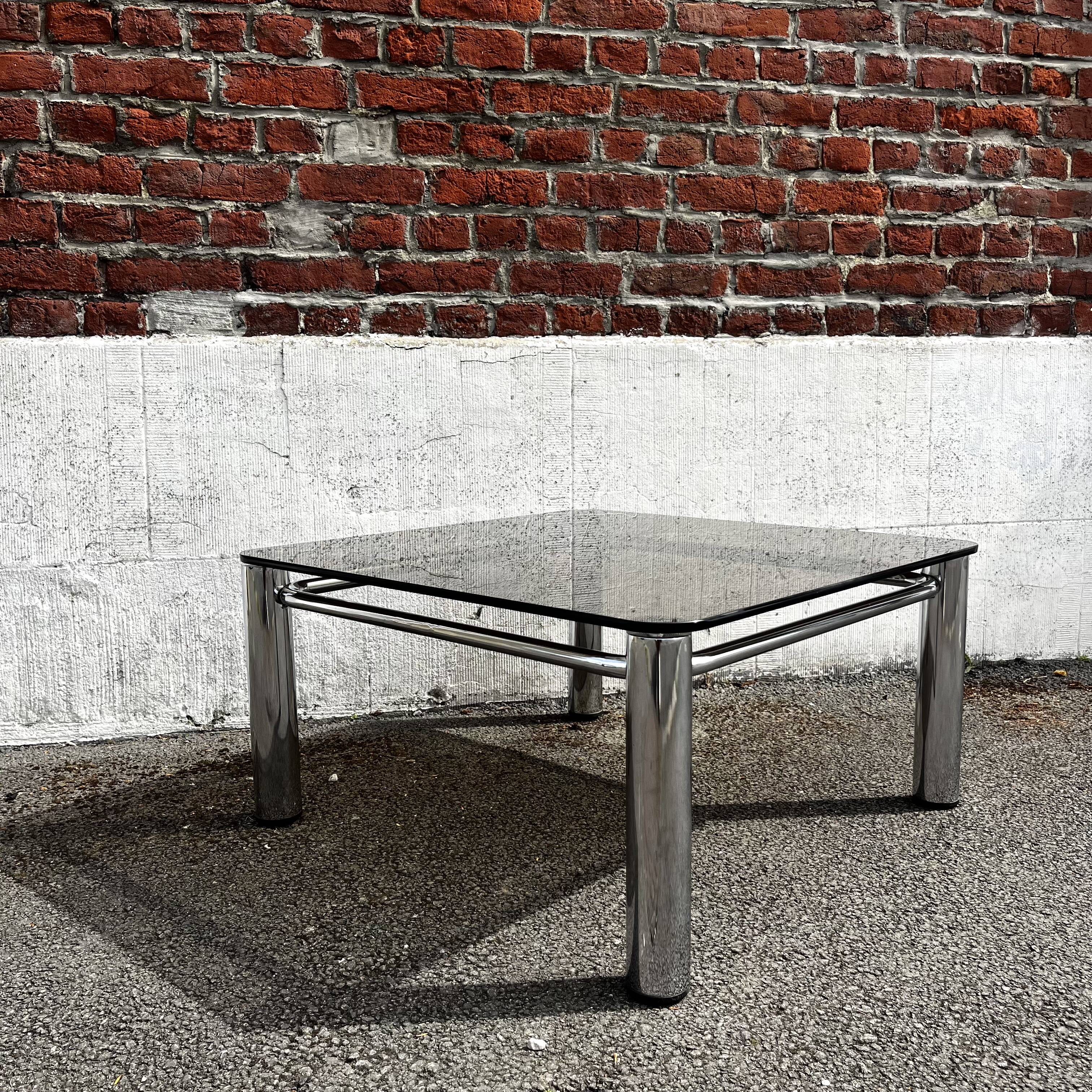 Vintage smoked glass coffee table with chrome structure.