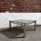 Vintage smoked glass coffee table with chrome structure.