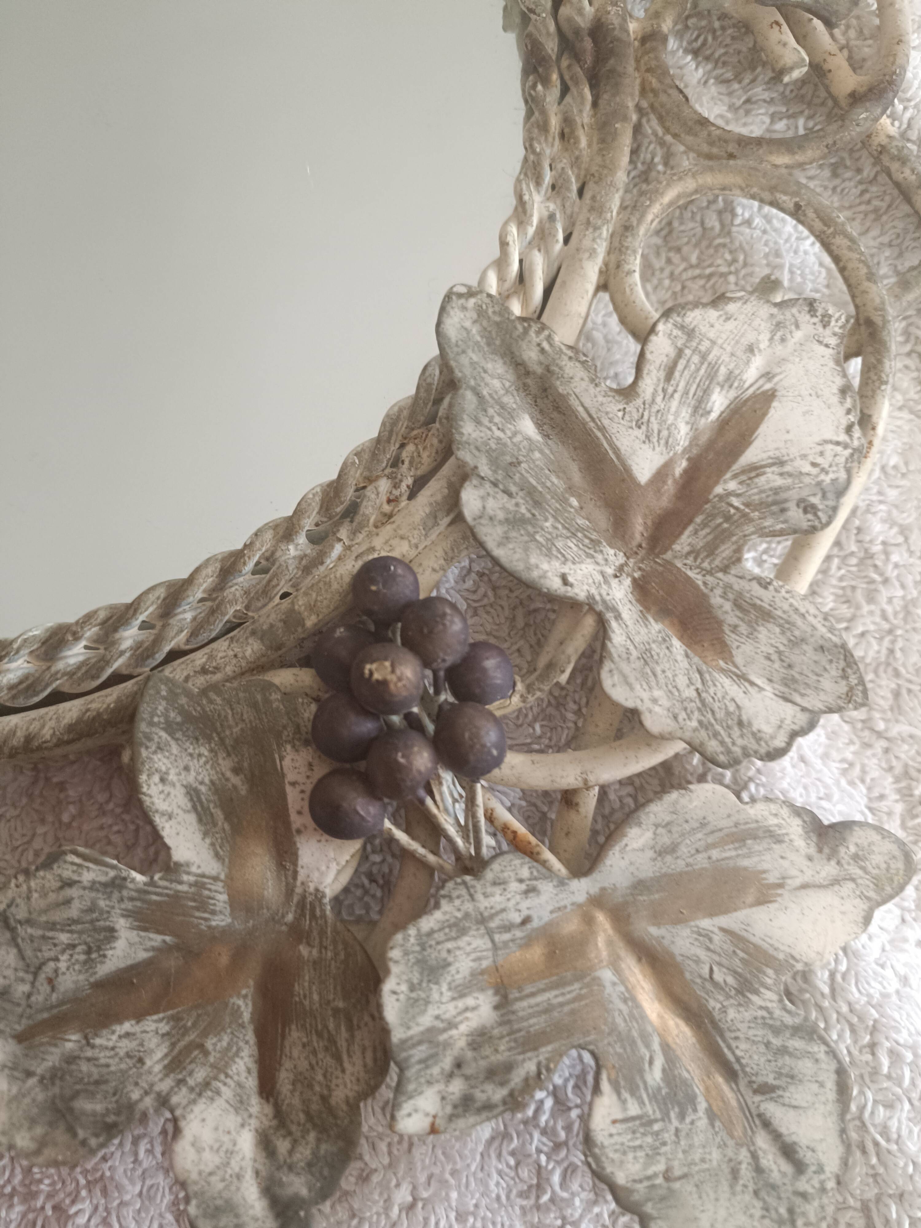 Wrought iron mirror. Grape leaf decoration.