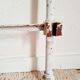 Cast-iron headboard and patinated white wood