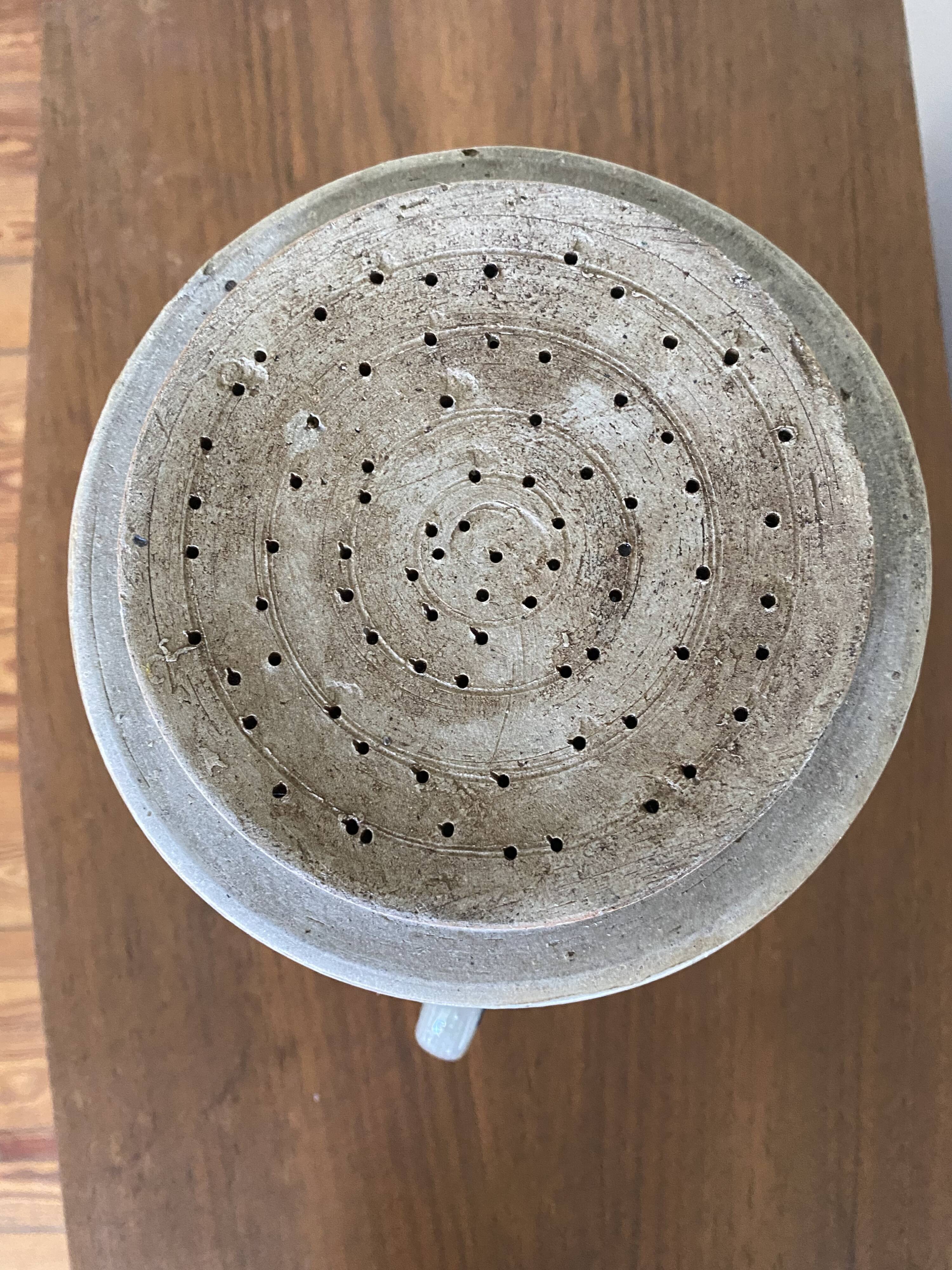 Old pot, sandstone, blue flower decoration