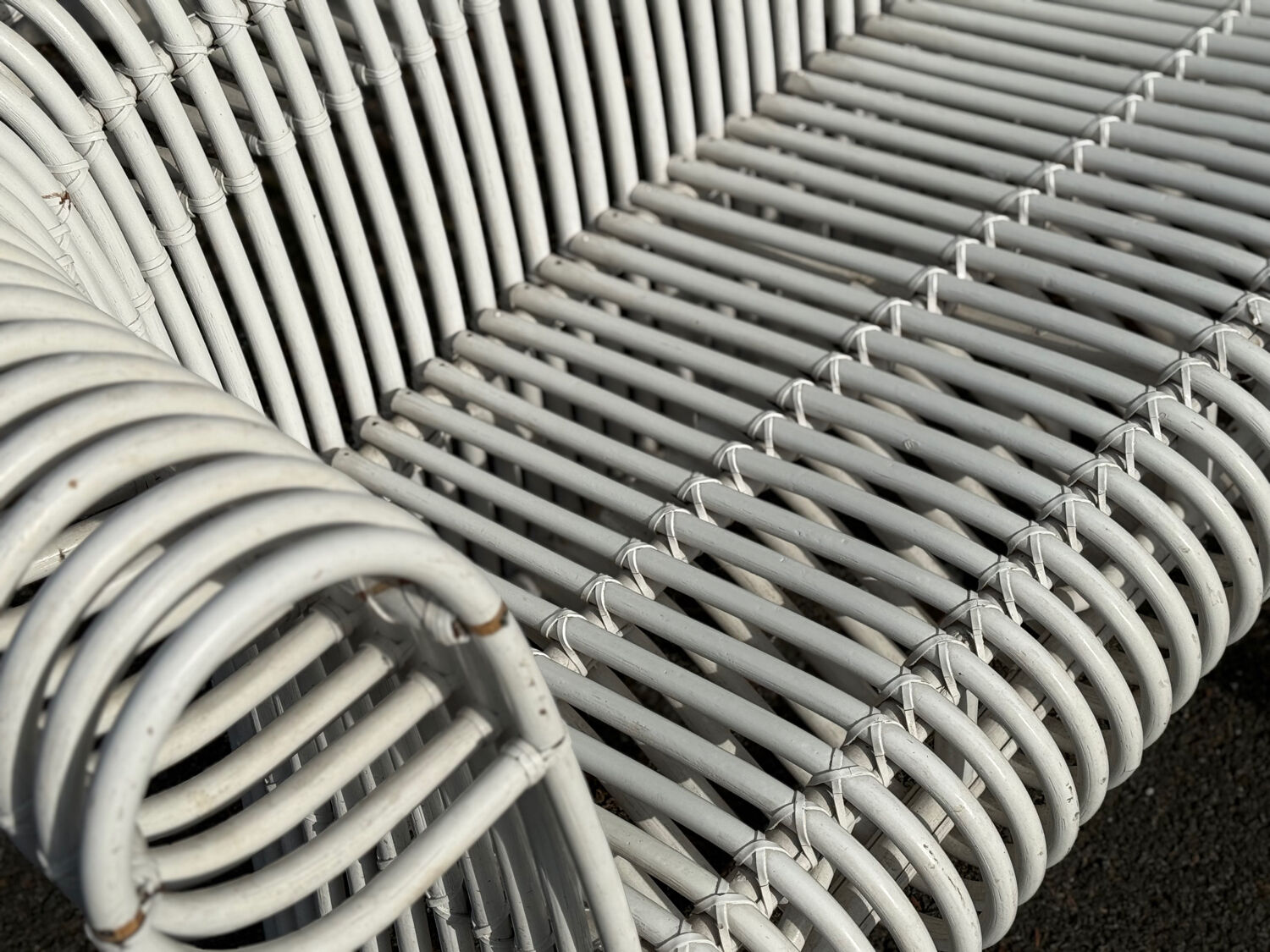 Rattan lounge with two two-seater sofas and a white coffee table.