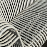 Rattan lounge with two two-seater sofas and a white coffee table.