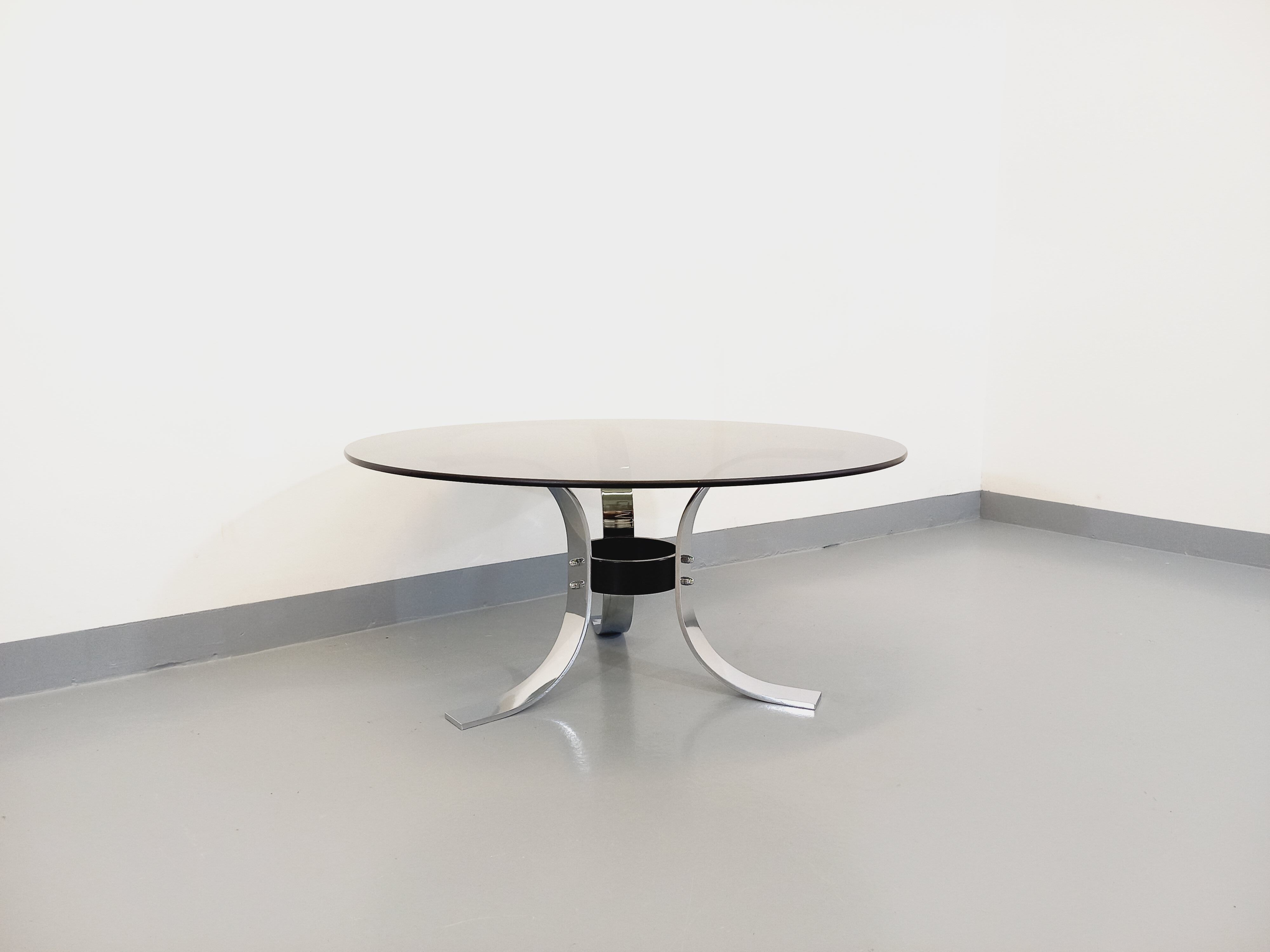 Vintage round coffee table in glass, chromed metal and black metal Space Age style of the 70s