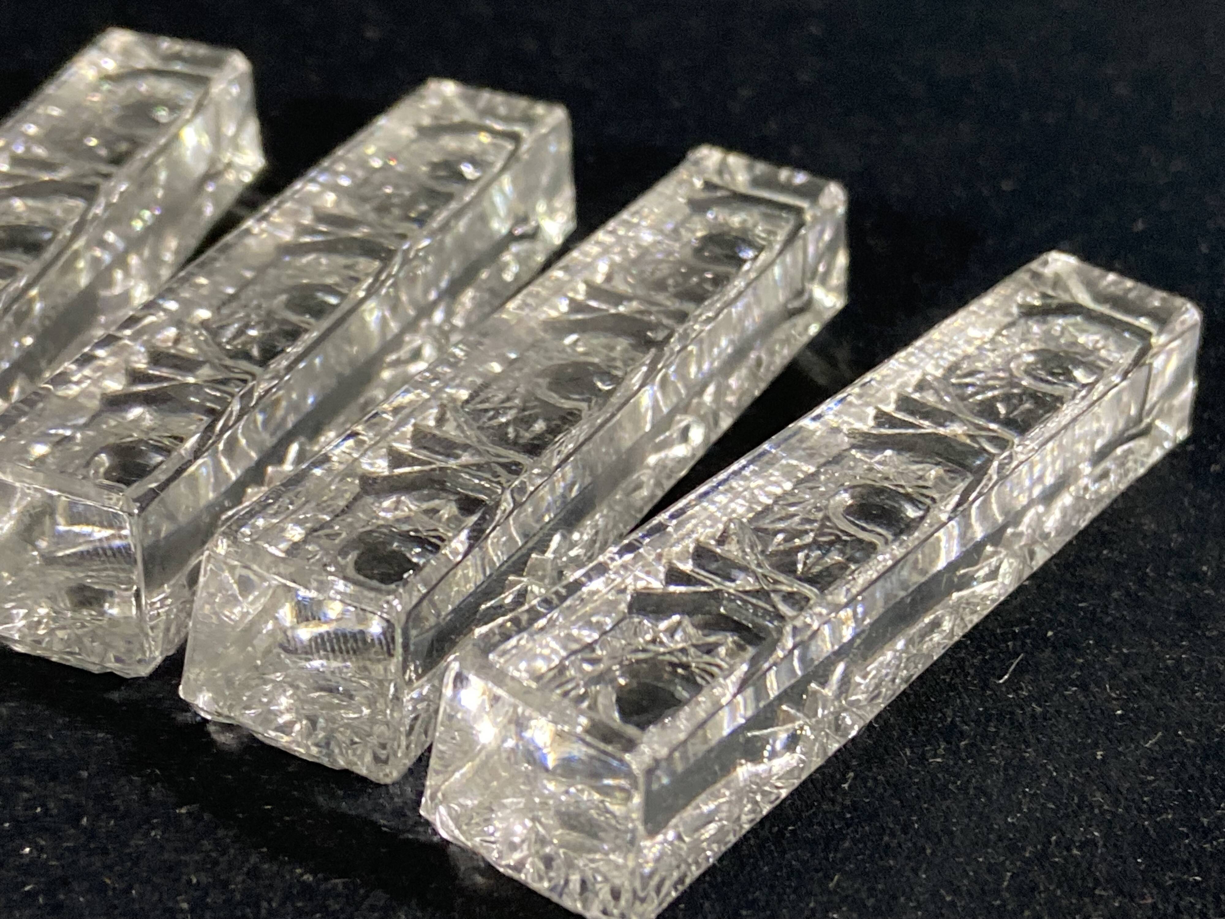 Set of 12 molded glass or crystal knife rests with diamond point decor