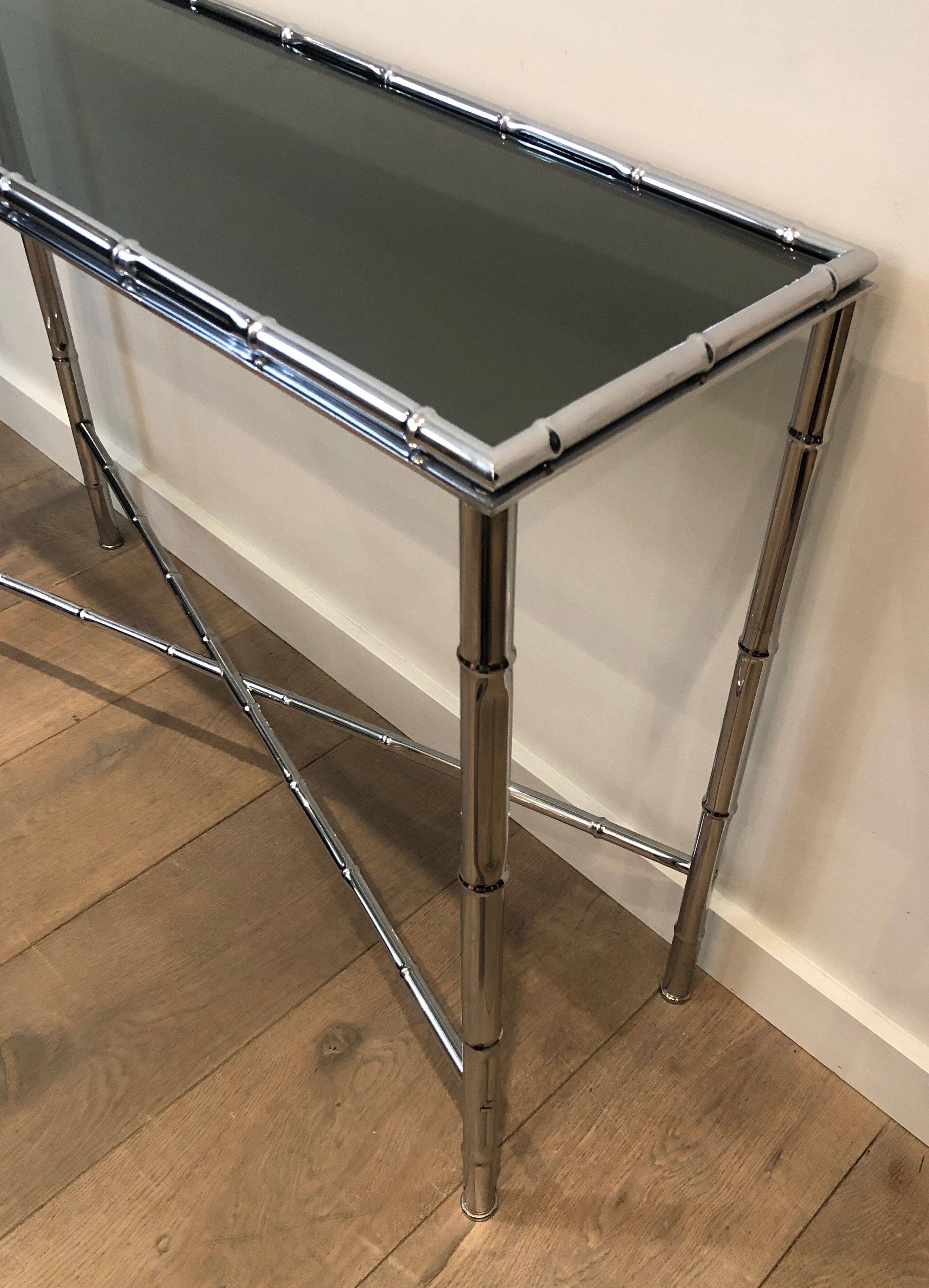 Console and chrome faux-bamboo mirror