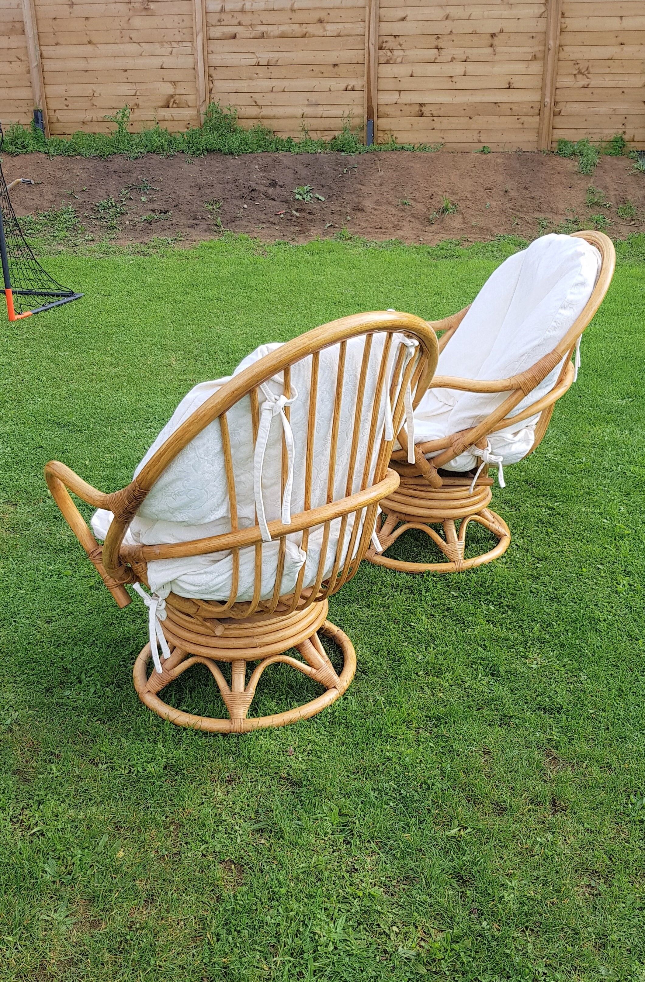 Pair of swivel rattan armchairs