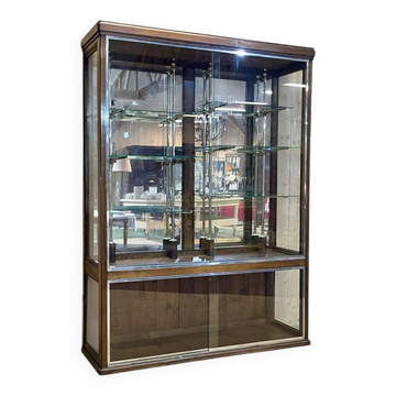 Early 20th-century shop display cabinet in oak with sliding doors.