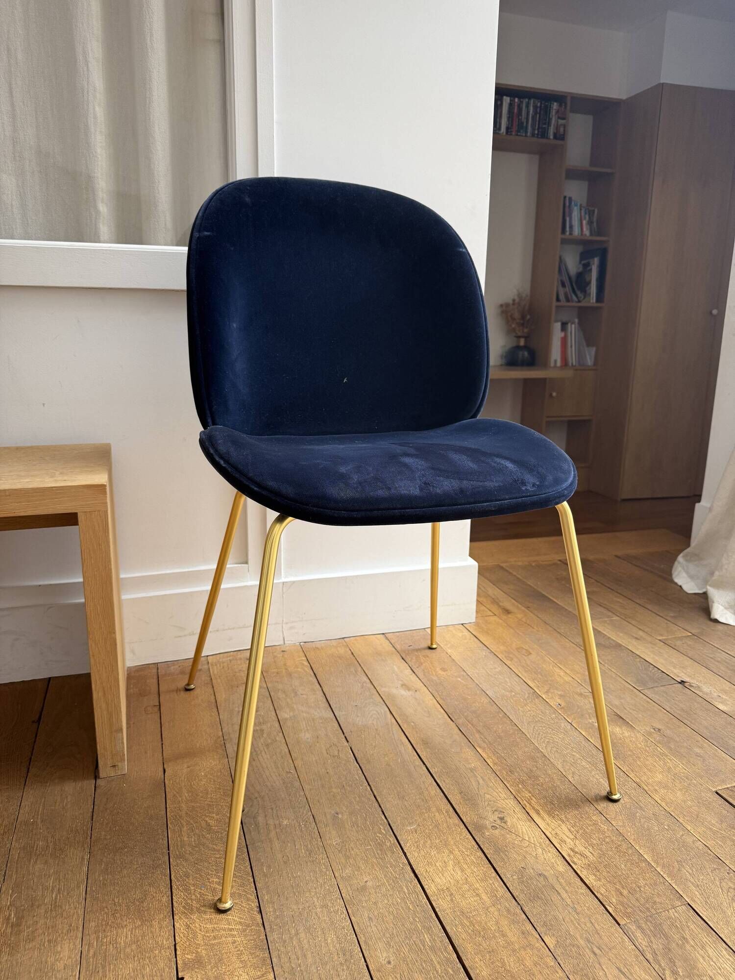 GUBI Beetle designer chair in midnight blue velvet with brass base