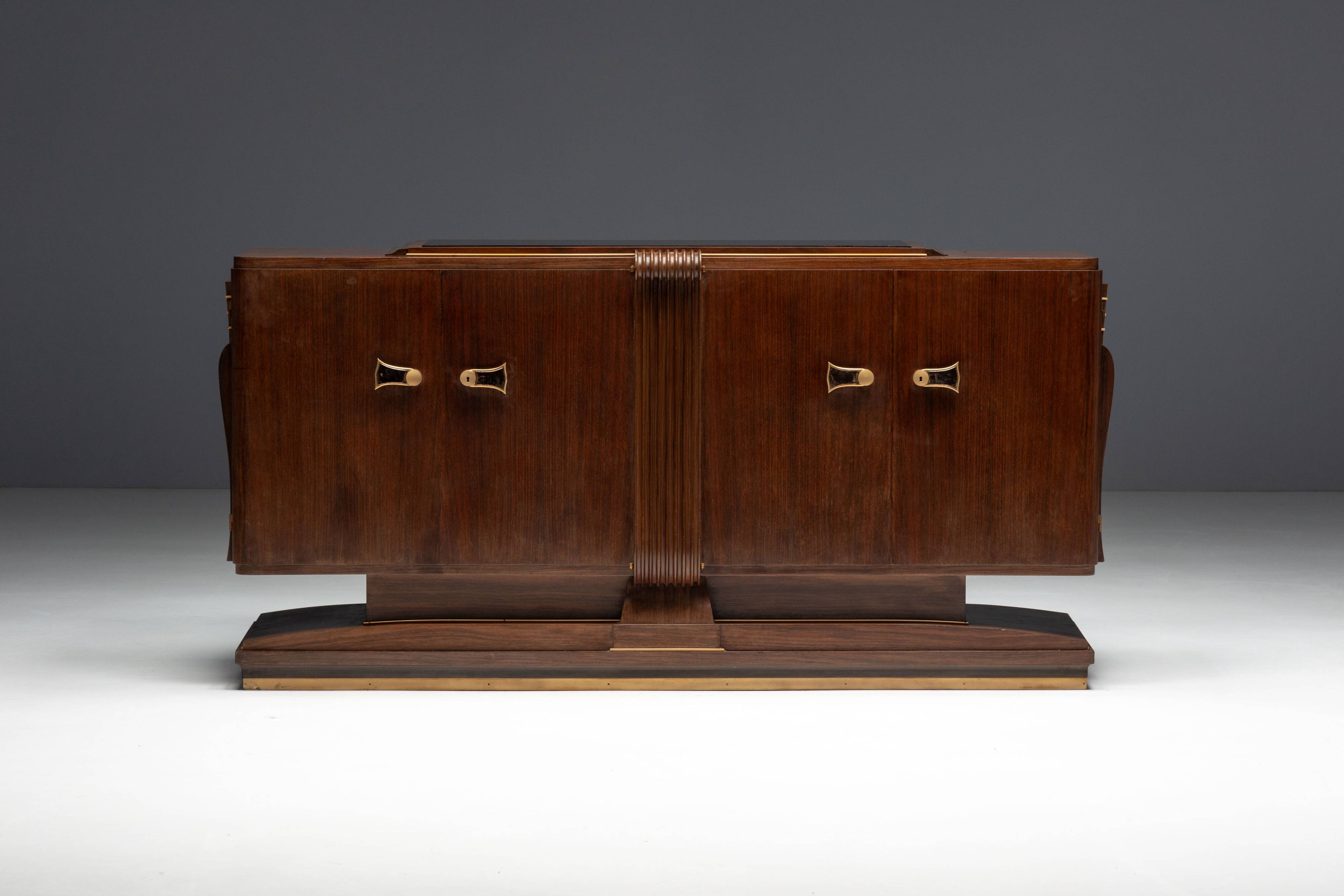 Art Deco walnut sideboard with brass details and sculptural base, France, 1930s