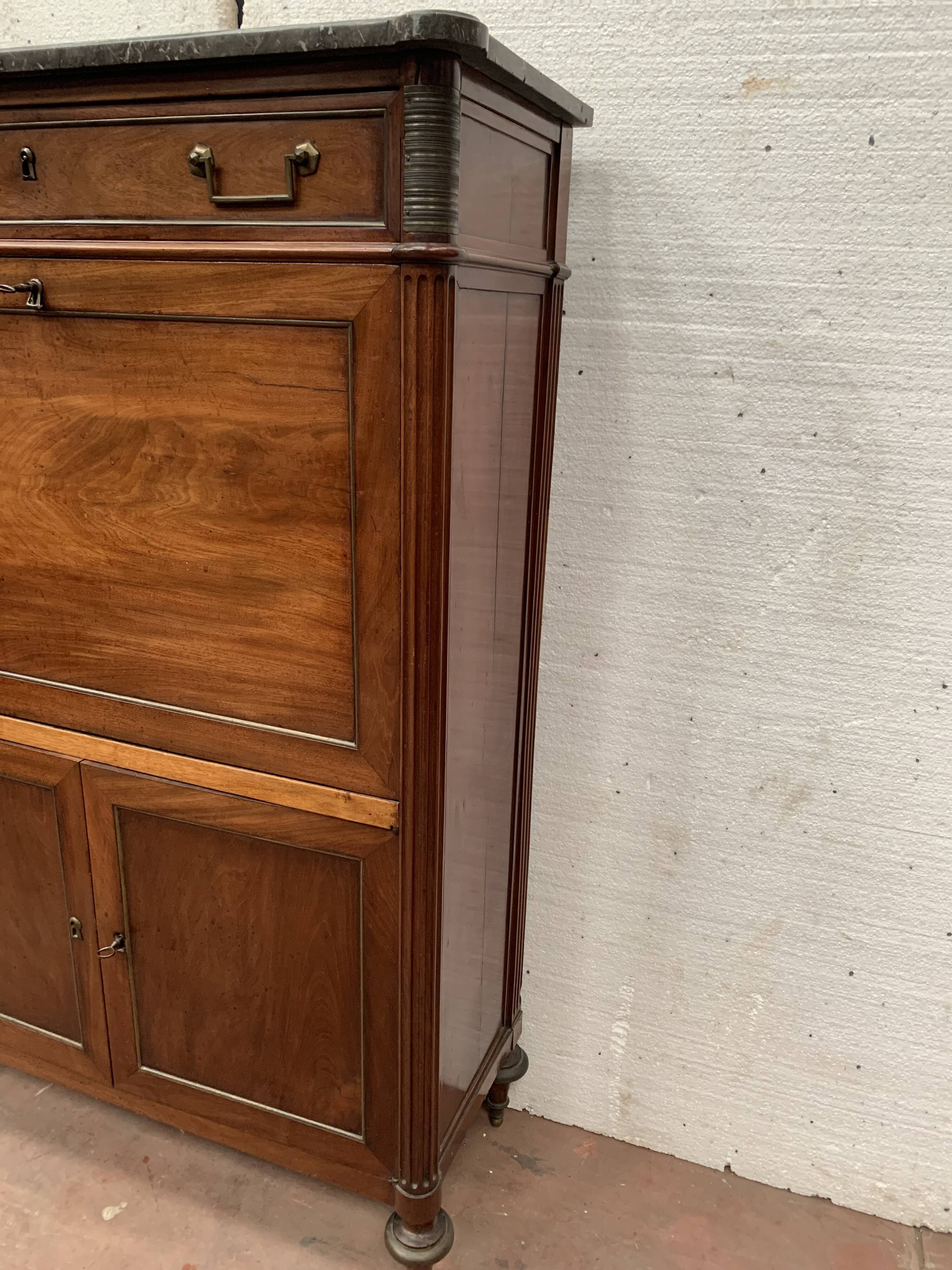 Secretary Louis XVI in mahogany Top of veined gray marble XIX century