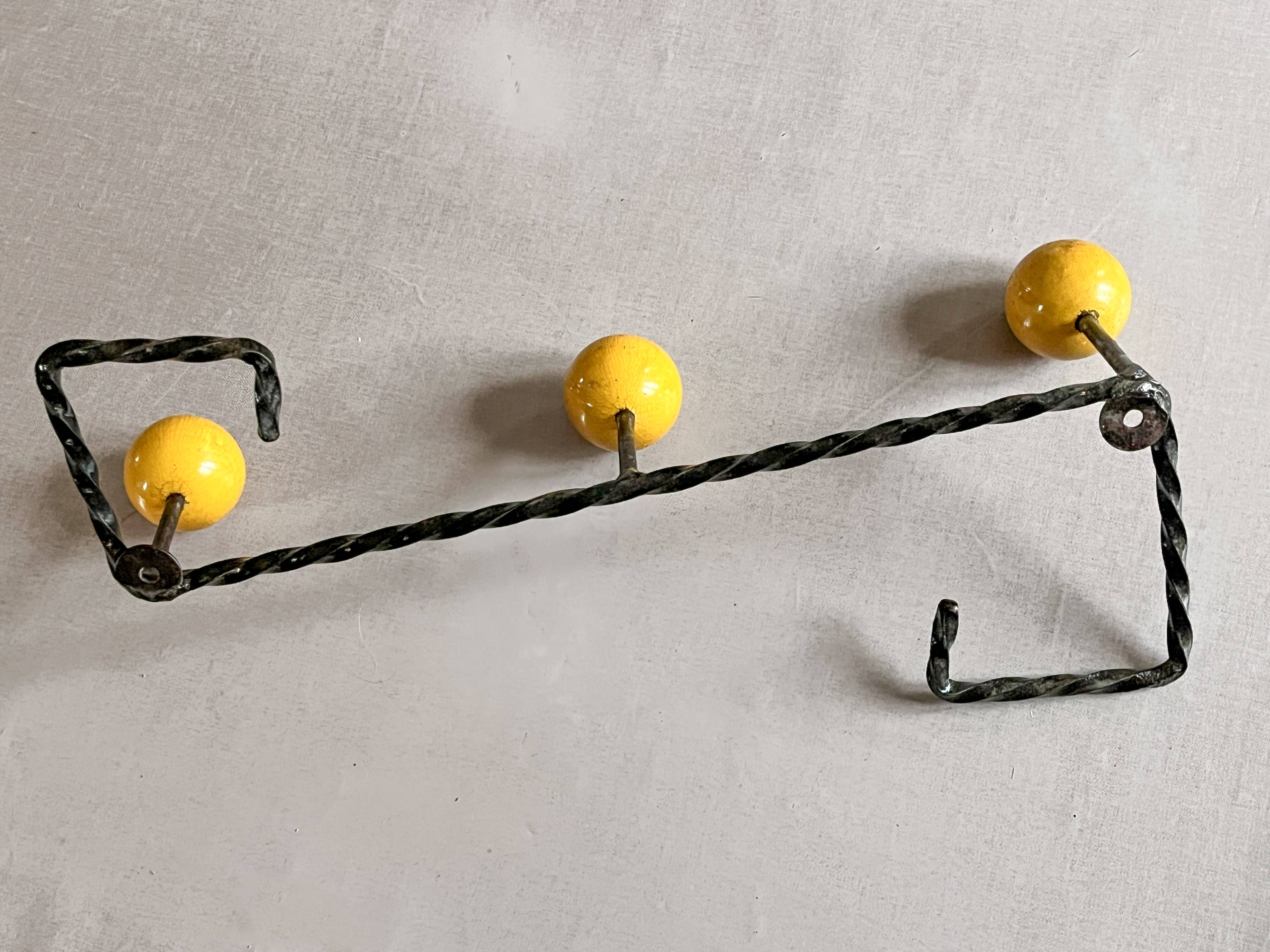 Wall-mounted coat rack in metal and wood with 3 hooks, antique item.