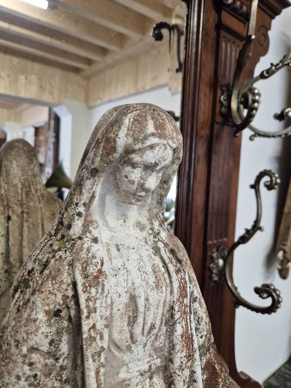 Garden statue of the Virgin Mary in old reconstituted stone