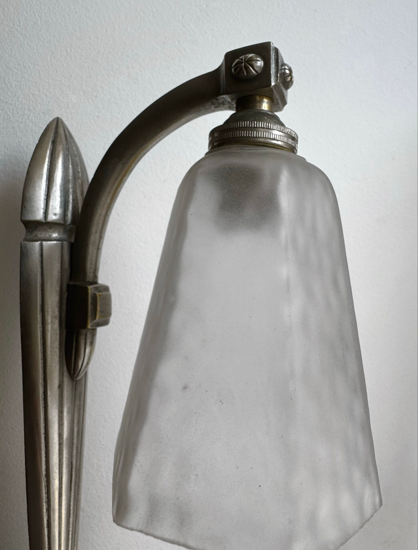 Silver Art Deco wall lights with frosted glass.