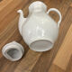 Vintage coffee pot in white porcelain with a gold trim.