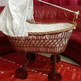 Vintage wicker cradle on wheels from the 1970s.
