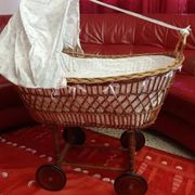 Vintage wicker cradle on wheels from the 1970s.
