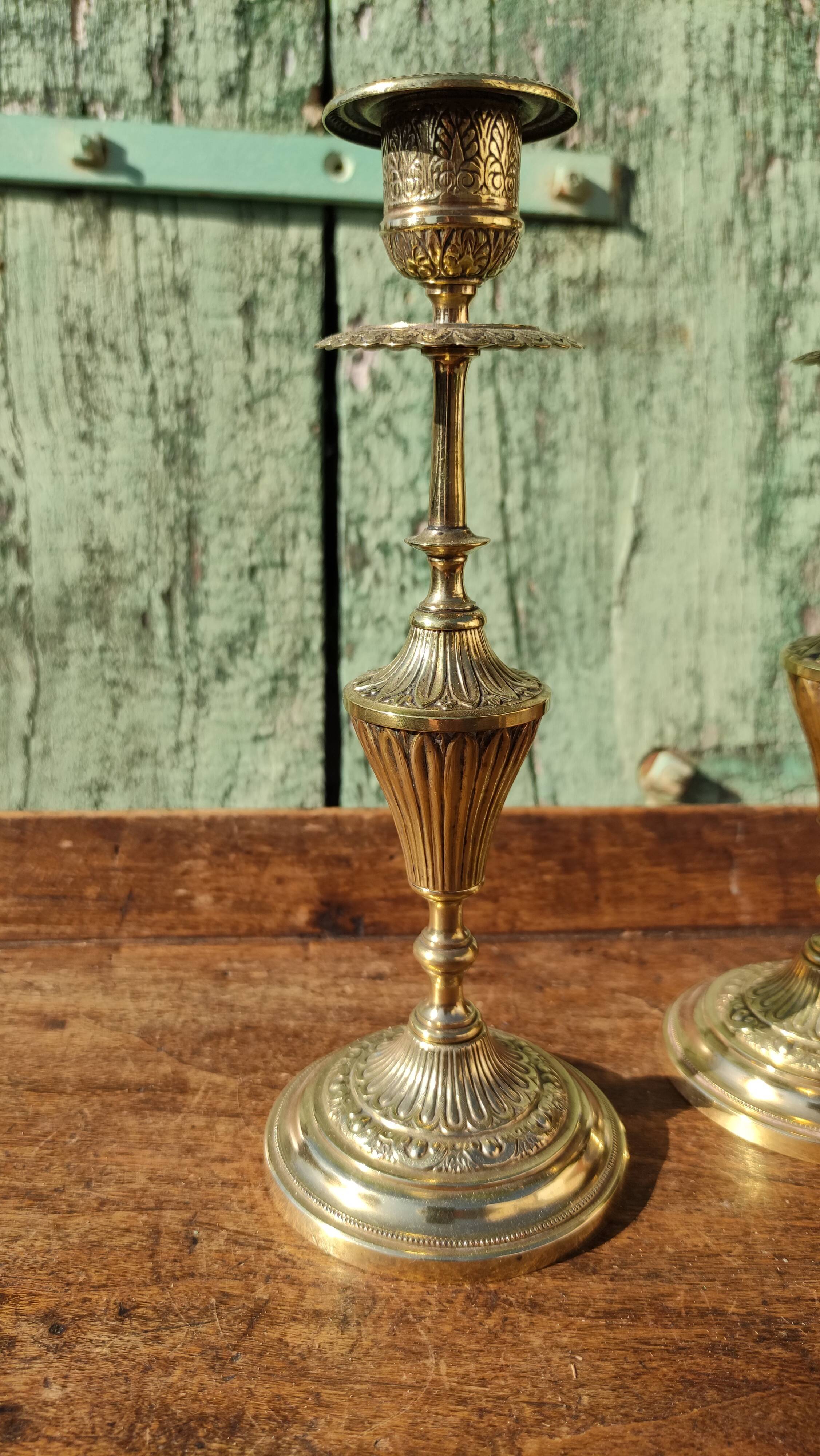 Pair of chiseled brass candle holders