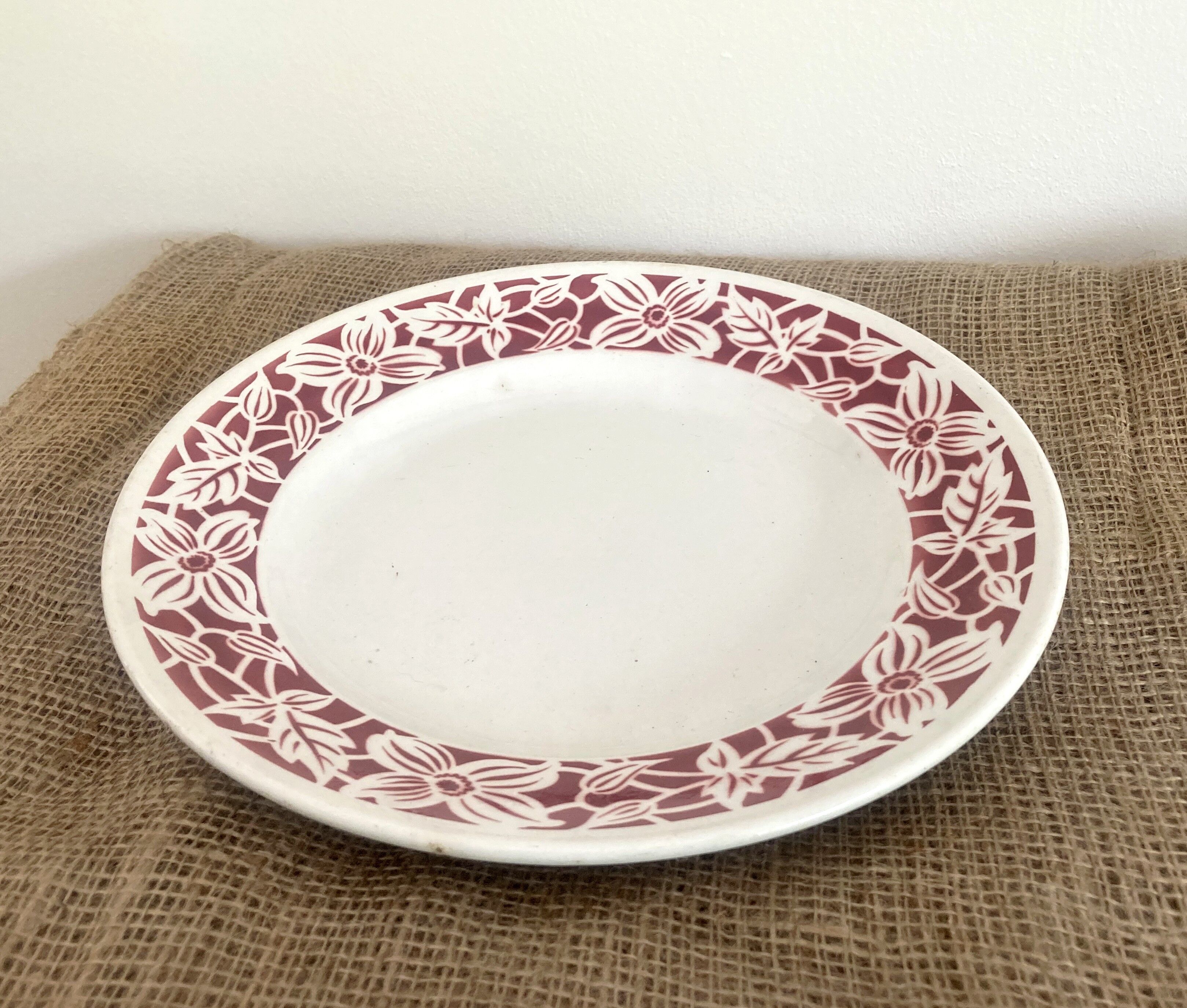 Round serving dish with burgundy red floral pattern