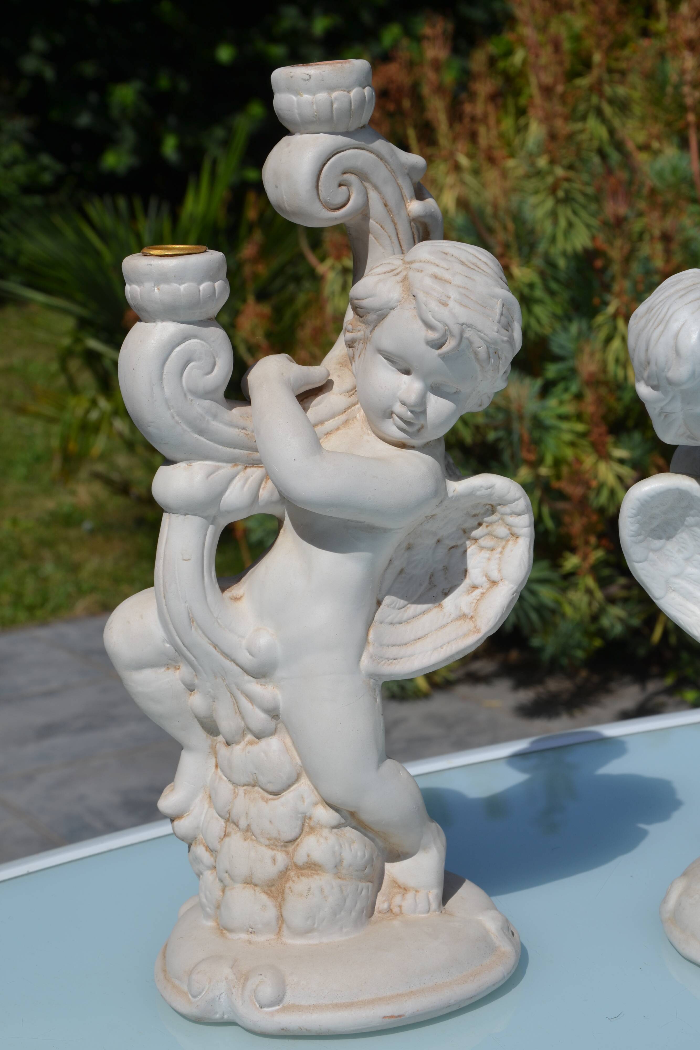 Pair of "cherub" candle holders in plaster
