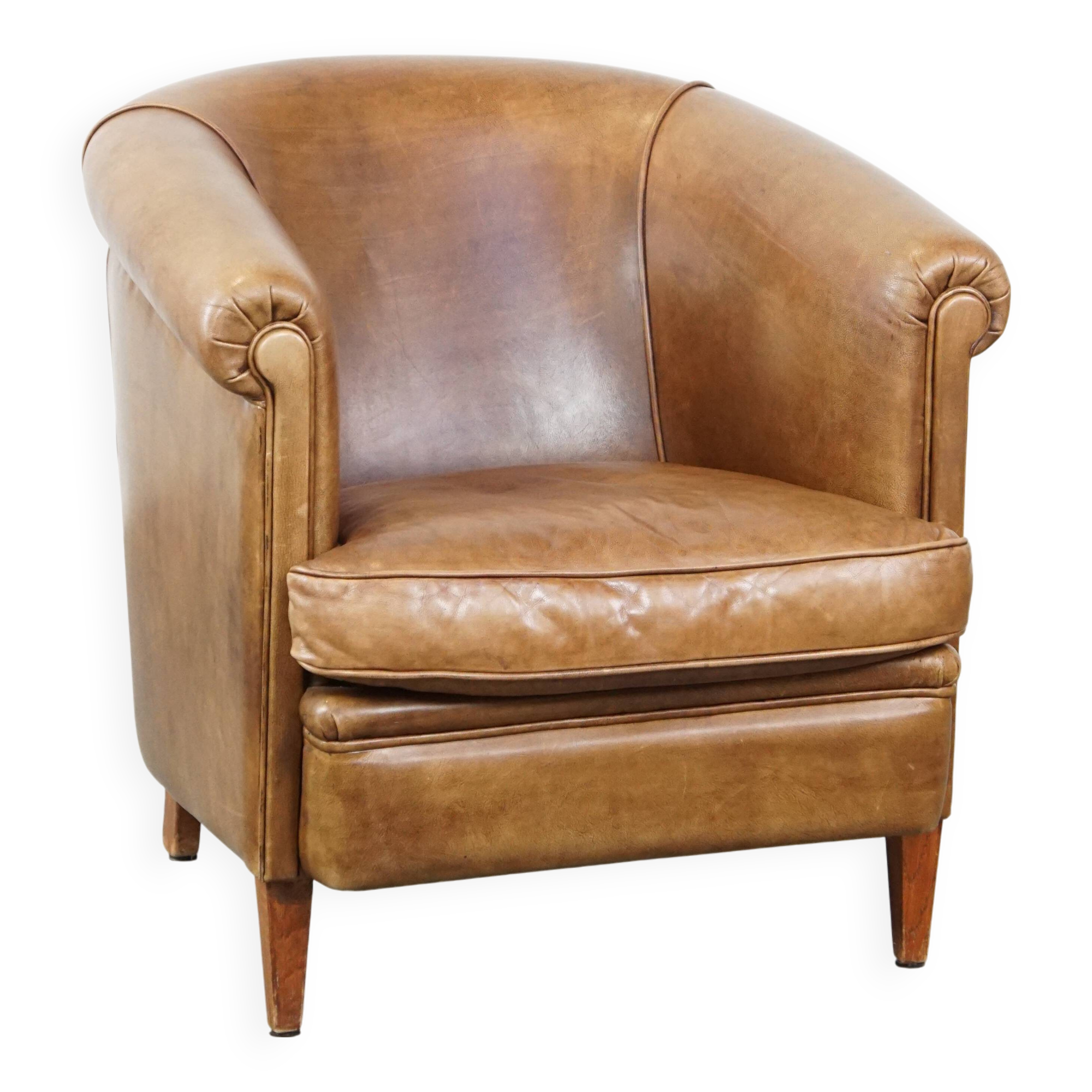 Club chair in light cognac-colored cowhide leather