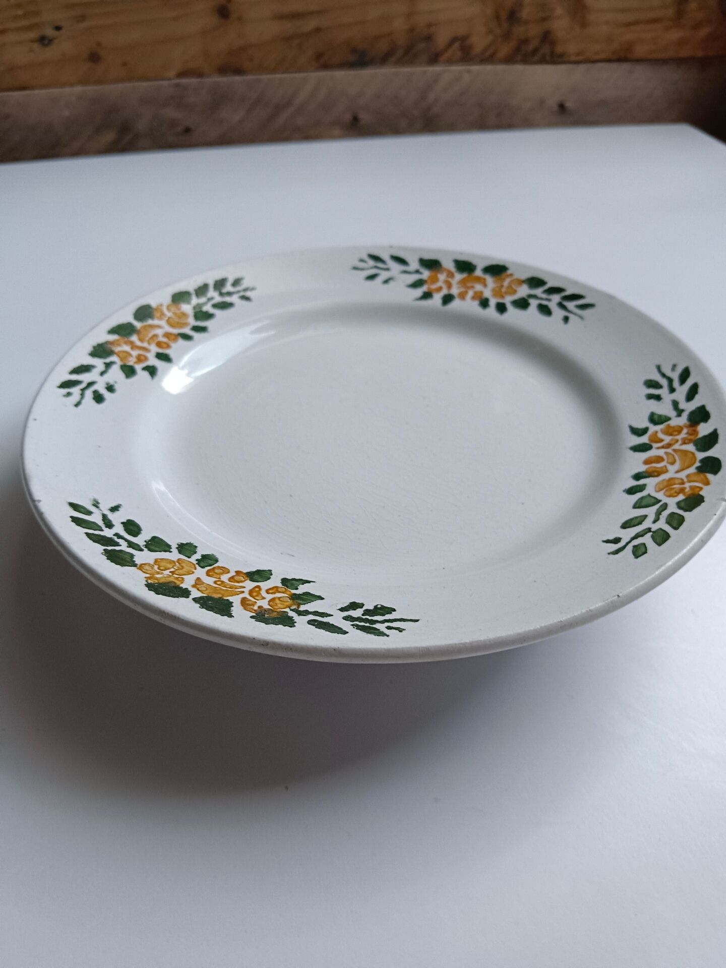 Old round footed plate signed Labrut brothers flowers