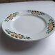 Old round footed plate signed Labrut brothers flowers