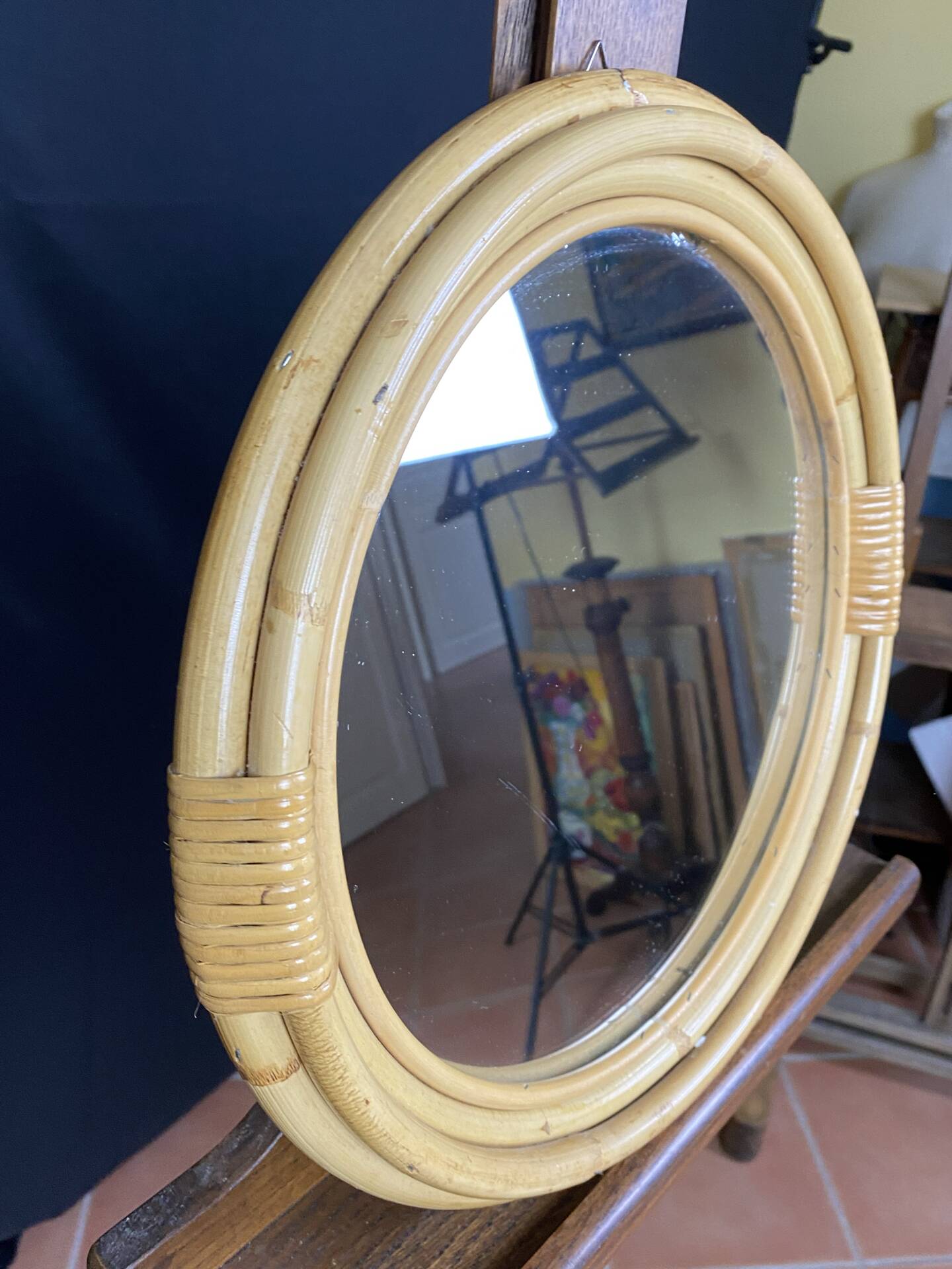 Round mirror from the 1960s with a frame made of rattan and metal.