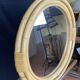 Round mirror from the 1960s with a frame made of rattan and metal.