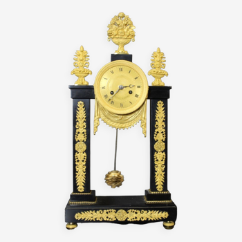 Period portico clock Restoration in black marble and gilded bronze early XIX